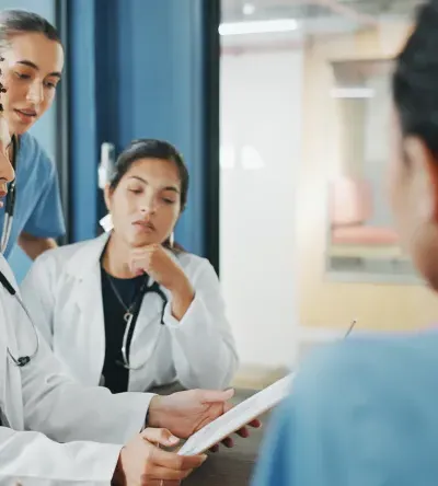 Nurse executive with DNP and medical team in background